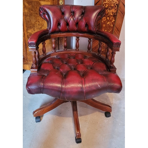 39 - A GOOD QUALITY OX-BLOOD LEATHER CHESTERFIELD STYLE REVOLVING CAPTAINS DESK CHAIR, with padded deep b... 