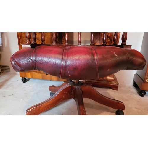 39 - A GOOD QUALITY OX-BLOOD LEATHER CHESTERFIELD STYLE REVOLVING CAPTAINS DESK CHAIR, with padded deep b... 