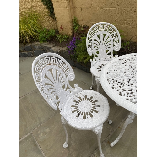 68 - A DECORATIVE CAST ALLOY GARDEN FURNITURE SUITE, to include four chairs and table. The garden chairs ... 