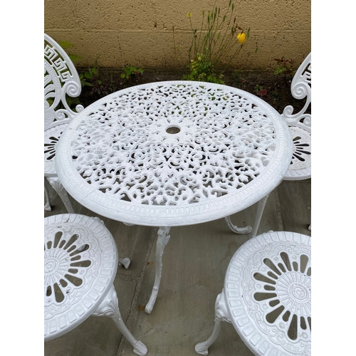 68 - A DECORATIVE CAST ALLOY GARDEN FURNITURE SUITE, to include four chairs and table. The garden chairs ... 