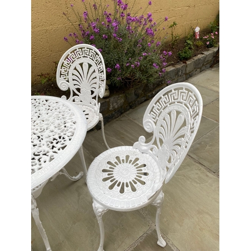 68 - A DECORATIVE CAST ALLOY GARDEN FURNITURE SUITE, to include four chairs and table. The garden chairs ... 