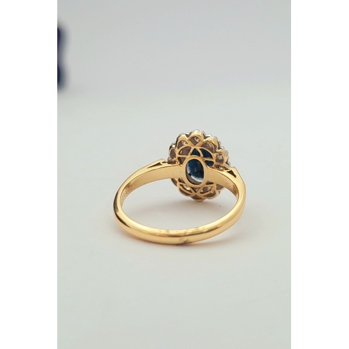 7 - A STUNNING 18CT YELLOW GOLD DIAMOND & SAPPHIRE CLUSTER RING, with a central oval deep blue sapphire ... 