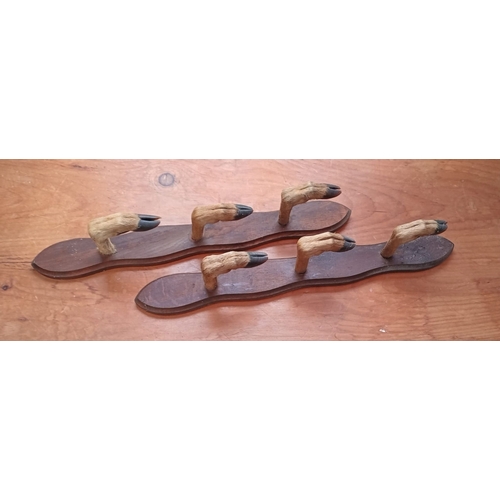 77 - AN UNUSUAL PAIR OF VINTAGE OAK TAXIDERMY MOUNTED GUN RACKS, formed of three taxidermy hooves hooks t... 