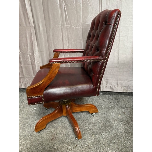 8 - A CHESTERFIELD STYLE OX-BLOOD LEATHER BUTTON BACKED ADJUSTABLE OFFICE / LIBRARY CHAIR, the camel sha... 