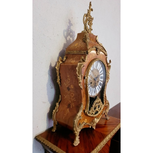 9 - A VINTAGE GERMAN FRANZ HERMLE ROCOCO STYLE MANTLE CLOCK, the shaped clock decorated with brass ormol... 