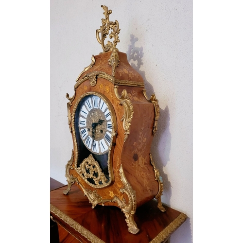 9 - A VINTAGE GERMAN FRANZ HERMLE ROCOCO STYLE MANTLE CLOCK, the shaped clock decorated with brass ormol... 