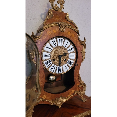 9 - A VINTAGE GERMAN FRANZ HERMLE ROCOCO STYLE MANTLE CLOCK, the shaped clock decorated with brass ormol... 