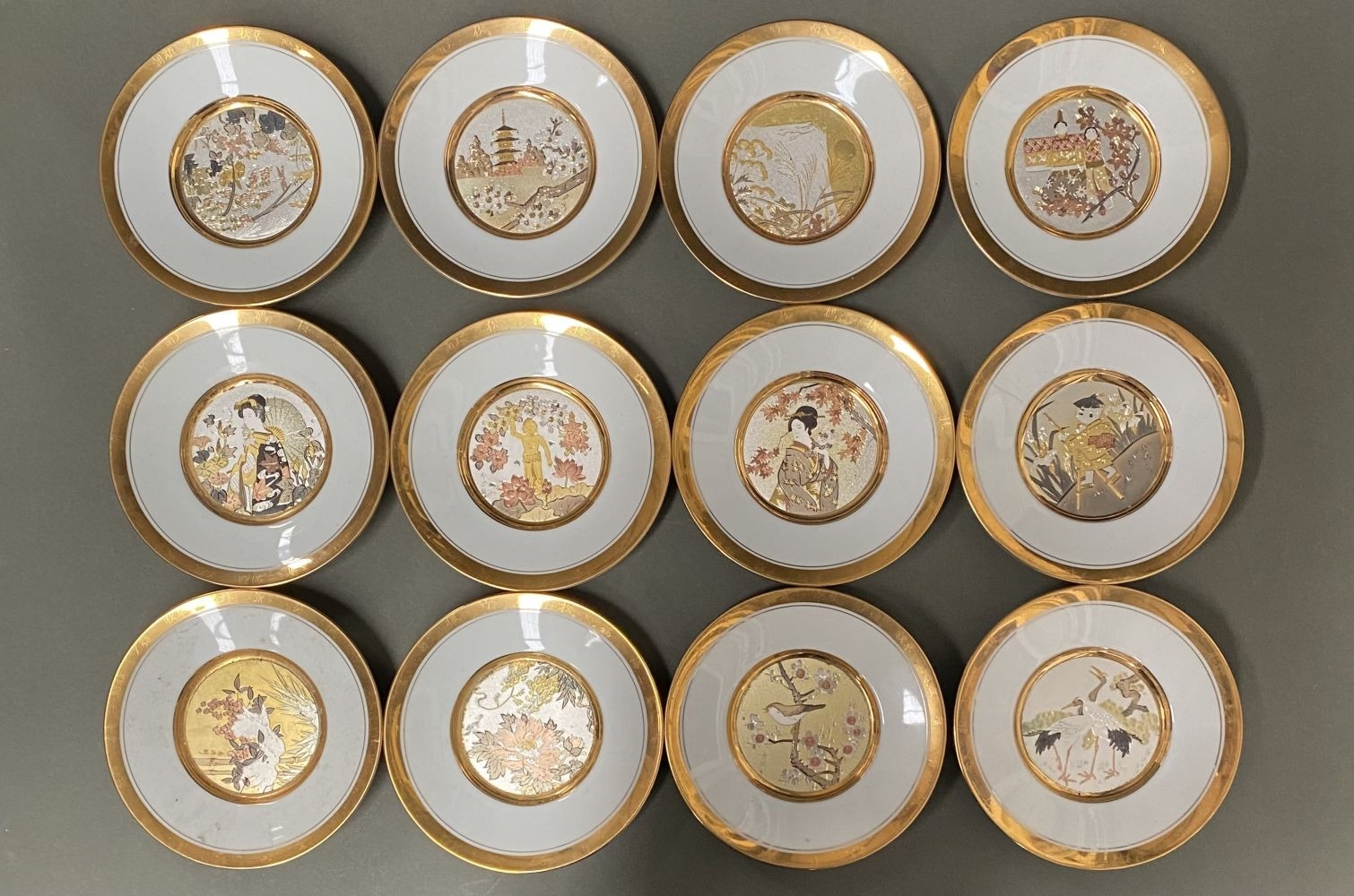 A COLLECTION OF 12 JAPANESE FLORAL CALENDER CHOKIN PLATES, from 