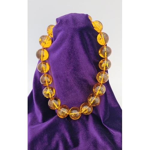 329 - A CHUNKY HONEY COLOURED AMBER NECKLET, with twist clasp. Nice warm honey colour from the beads.