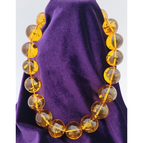 329 - A CHUNKY HONEY COLOURED AMBER NECKLET, with twist clasp. Nice warm honey colour from the beads.