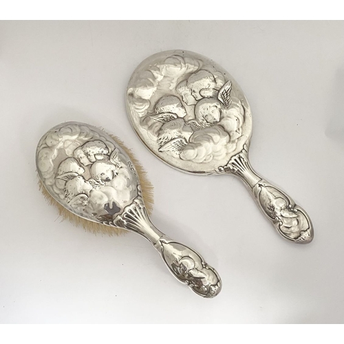 12 - A DECORATIVE EDWARD VII SILVER HAND MIRROR & HAIRBRUSH, by William Comyns & Sons, Manufacturing silv... 