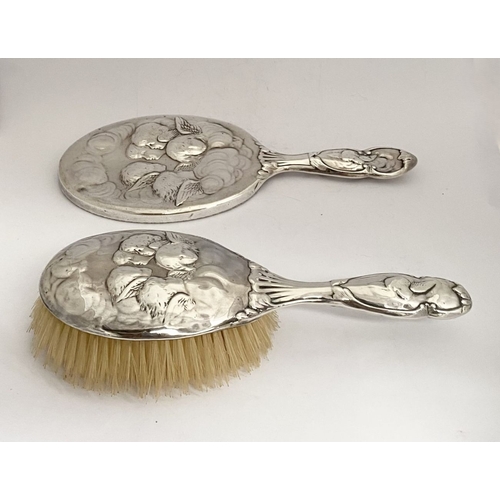 12 - A DECORATIVE EDWARD VII SILVER HAND MIRROR & HAIRBRUSH, by William Comyns & Sons, Manufacturing silv... 