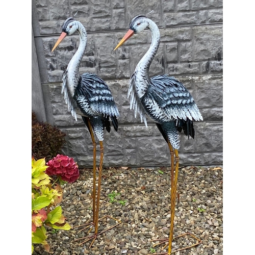 31 - A LARGE PAIR OF PAINTED STEEL GARDEN ORNAMENTS IN THE FORM OF HERONS, dimensions: 98cm high approx.