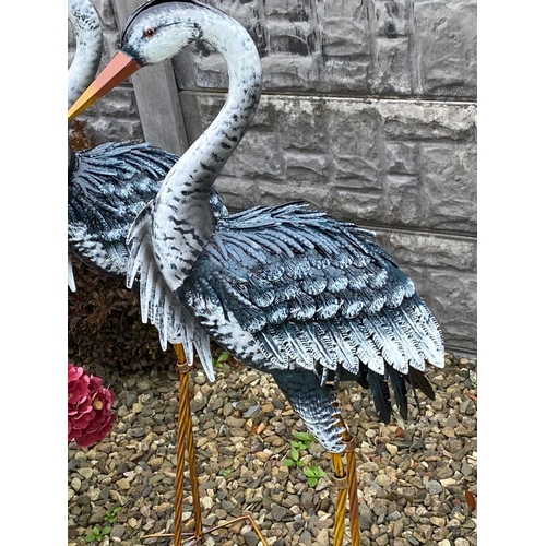 31 - A LARGE PAIR OF PAINTED STEEL GARDEN ORNAMENTS IN THE FORM OF HERONS, dimensions: 98cm high approx.