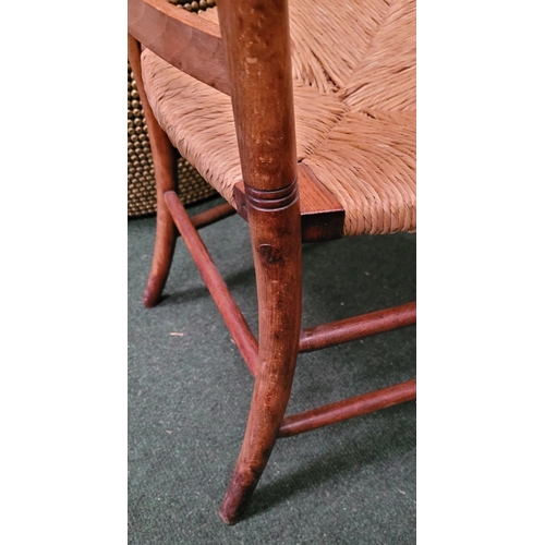 55 - A GEORGIAN STYLE OAK & RUSH LADDER BACK ARMCHAIR, with ring turned uprights to the back and five sha... 