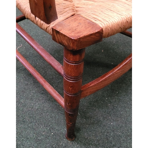 55 - A GEORGIAN STYLE OAK & RUSH LADDER BACK ARMCHAIR, with ring turned uprights to the back and five sha... 