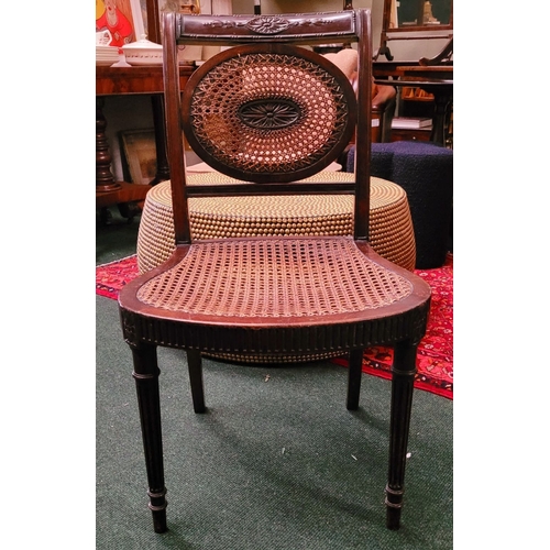 56 - AN EDWARDIAN BERGÉRE MAHOGANY CHAIR, in the Adam style, with carved floral knees & reed detail to th... 