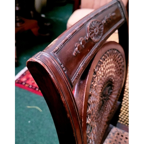 56 - AN EDWARDIAN BERGÉRE MAHOGANY CHAIR, in the Adam style, with carved floral knees & reed detail to th... 