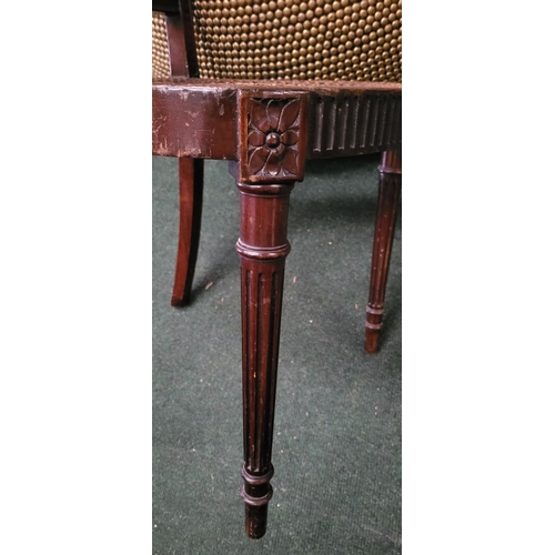 56 - AN EDWARDIAN BERGÉRE MAHOGANY CHAIR, in the Adam style, with carved floral knees & reed detail to th... 