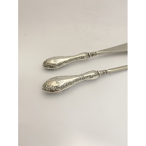 62 - AN EDWARDIAN SILVER SHOEHORN, BUTTON HOOK & CUTICLE PUSHER, the shoe horn and button hook engraved ‘... 