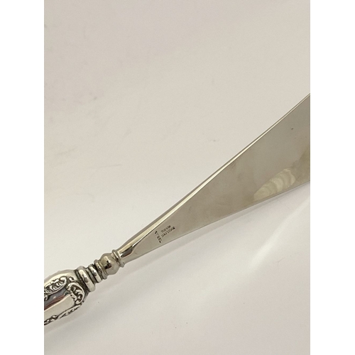 62 - AN EDWARDIAN SILVER SHOEHORN, BUTTON HOOK & CUTICLE PUSHER, the shoe horn and button hook engraved ‘... 