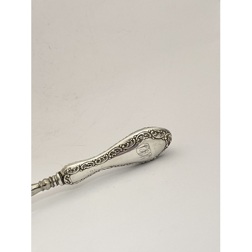 62 - AN EDWARDIAN SILVER SHOEHORN, BUTTON HOOK & CUTICLE PUSHER, the shoe horn and button hook engraved ‘... 