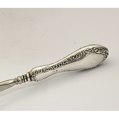 62 - AN EDWARDIAN SILVER SHOEHORN, BUTTON HOOK & CUTICLE PUSHER, the shoe horn and button hook engraved ‘... 