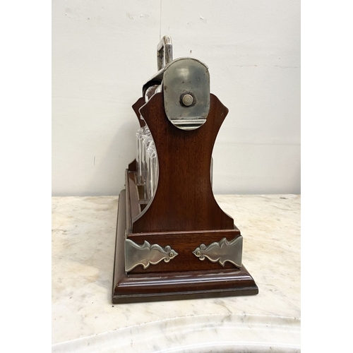 63 - AN EXCELLENT MAHOGANY THREE BOTTLE TANTULUS, with decorative white metal cartouches, bindings and ha... 