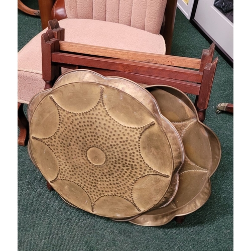 69 - A PAIR OF COLLAPSABLE BRASS TRAY TOP TABLES, each of the tables has a scalloped brass hand beaten tr... 