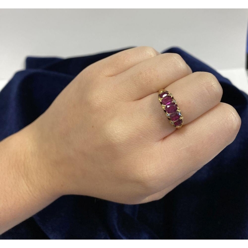 10 - A STRIKING 18CT YELLOW GOLD FIVE STONE RUBY RING, with five oval cut rubies graduating in size from ... 