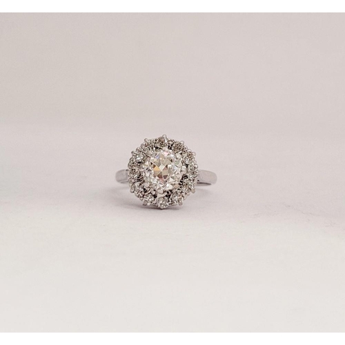 101 - A VERY FINE 18CT WHITE GOLD DIAMOND CLUSTER RING, with a large raised central round diamond, surroun... 