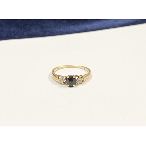 105 - A NICE 9CT YELLOW GOLD SAPPHIRE & DIAMOND CROSS OVER RING, with central oval cut sapphire in four pr... 