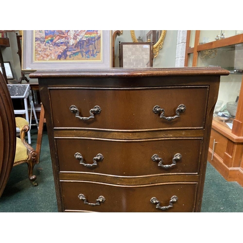 111 - A NEAT SIZED MAHOGANY CHEST OF DRAWERS, serpentine shaped, the top with crossbanded border and mould... 