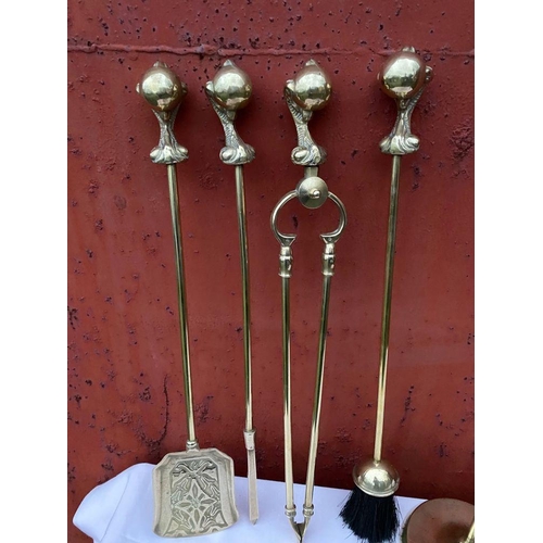 112 - A GOOD SET OF FOUR POLISHED BRASS FIRE IRONS ON STAND, to include shovel, brush, tongs and poker, al... 