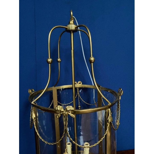 113 - A LARGE BRASS CIRCULAR SHAPED LANTERN, in working order. Finely decorated with glass panels surround... 