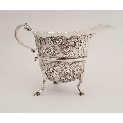 116 - A BEAUTIFULLY CRAFTED IRISH, CORK, GEORGE II SILVER CREAM JUG, finely decorated all over with repous... 