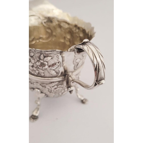 116 - A BEAUTIFULLY CRAFTED IRISH, CORK, GEORGE II SILVER CREAM JUG, finely decorated all over with repous... 