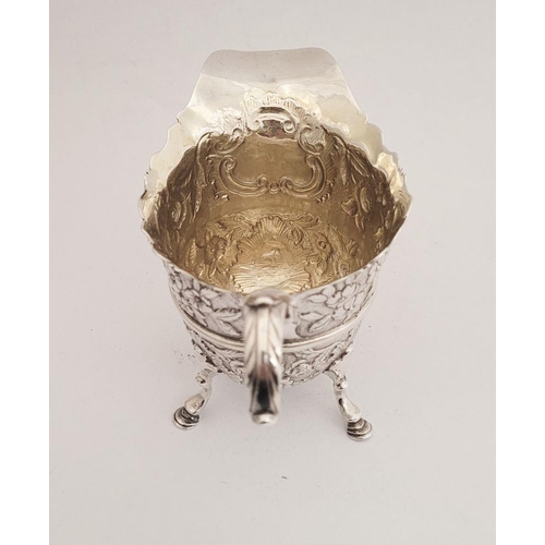 116 - A BEAUTIFULLY CRAFTED IRISH, CORK, GEORGE II SILVER CREAM JUG, finely decorated all over with repous... 