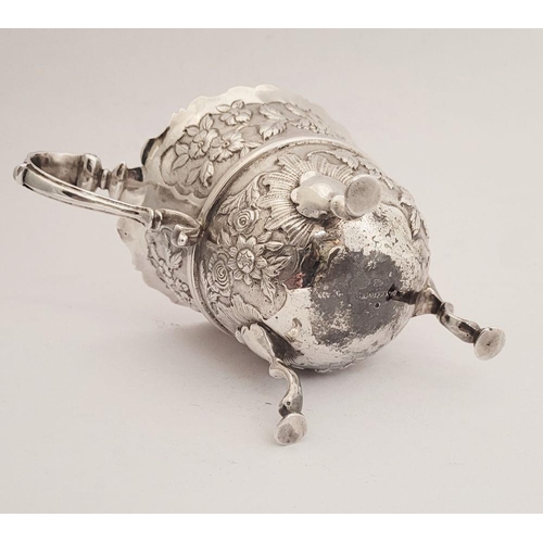 116 - A BEAUTIFULLY CRAFTED IRISH, CORK, GEORGE II SILVER CREAM JUG, finely decorated all over with repous... 