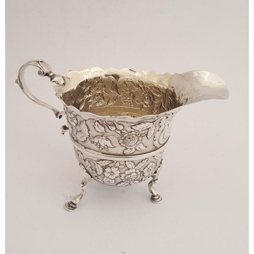 116 - A BEAUTIFULLY CRAFTED IRISH, CORK, GEORGE II SILVER CREAM JUG, finely decorated all over with repous... 