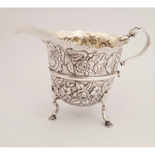 116 - A BEAUTIFULLY CRAFTED IRISH, CORK, GEORGE II SILVER CREAM JUG, finely decorated all over with repous... 