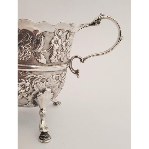 116 - A BEAUTIFULLY CRAFTED IRISH, CORK, GEORGE II SILVER CREAM JUG, finely decorated all over with repous... 