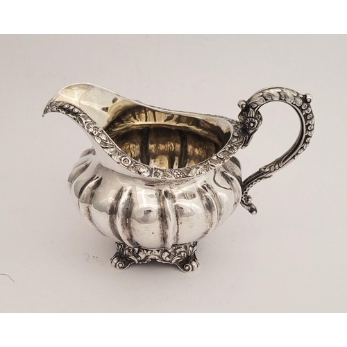 124 - A VERY GOOD  WILLIAM IV SILVER CREAM JUG, a beautifully decorated piece. Dating from 1834, created i... 