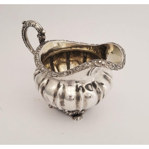 124 - A VERY GOOD  WILLIAM IV SILVER CREAM JUG, a beautifully decorated piece. Dating from 1834, created i... 