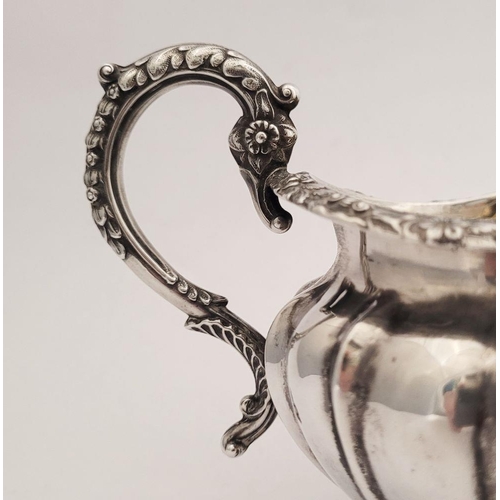 124 - A VERY GOOD  WILLIAM IV SILVER CREAM JUG, a beautifully decorated piece. Dating from 1834, created i... 