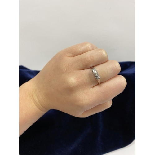 127 - A BEAUTIFUL PLATINUM THREE STONE DIAMOND RING, with central round brilliant cut diamond flanked by t... 