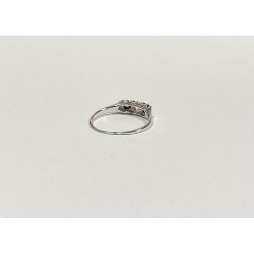 127 - A BEAUTIFUL PLATINUM THREE STONE DIAMOND RING, with central round brilliant cut diamond flanked by t... 