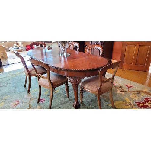 130 - A LARGE EXTENDABLE DINING TABLE, with gadrooned edging, raised on four carved cabriole shaped legs w... 