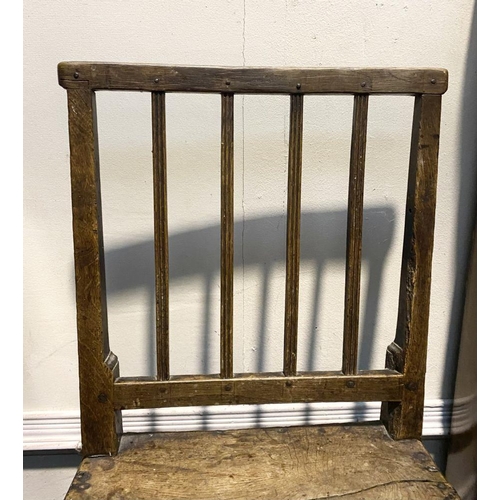 149 - A VINTAGE PROVINCIAL STYLE OAK DINING CHAIR, with four bar slatted back, straight legs joined by cro... 