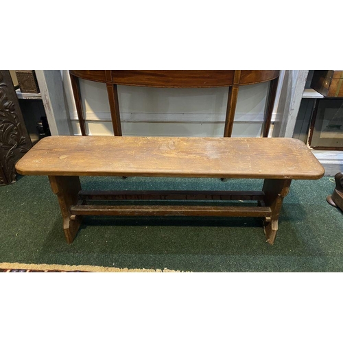 156 - A LONG HARDWOOD BENCH, the rectangular top with canted corners, with shaped supports joining a doubl... 